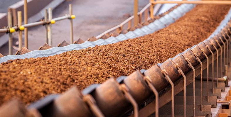 Iron ore being transported on a conveyor. 