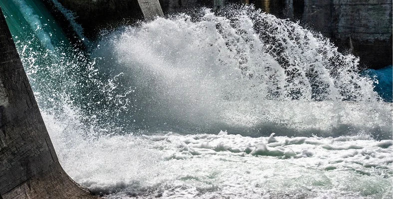 A close up of water cascading out of a hydropower plant.