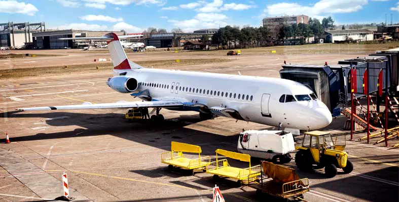 An airplane being loaded in a airport. 