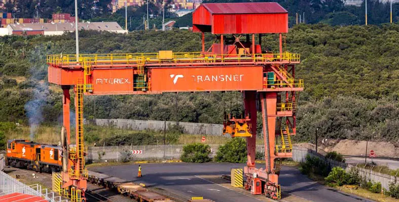 Some heavy logistics equipment branded with Transnet logo.