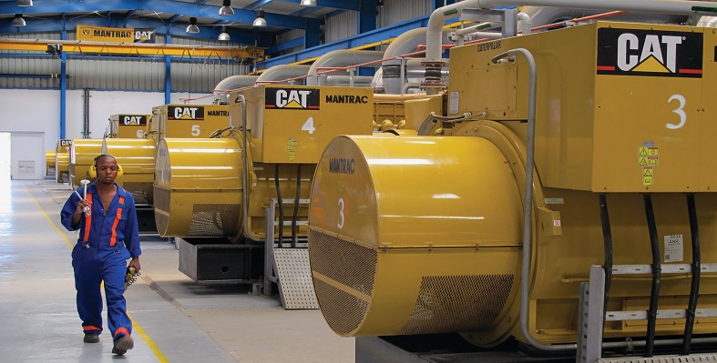 A caterpillar diesel generator covered in plastic being delivered to a customer in Gabon