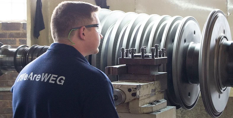 A WEG Africa employee looking at a turbine. 