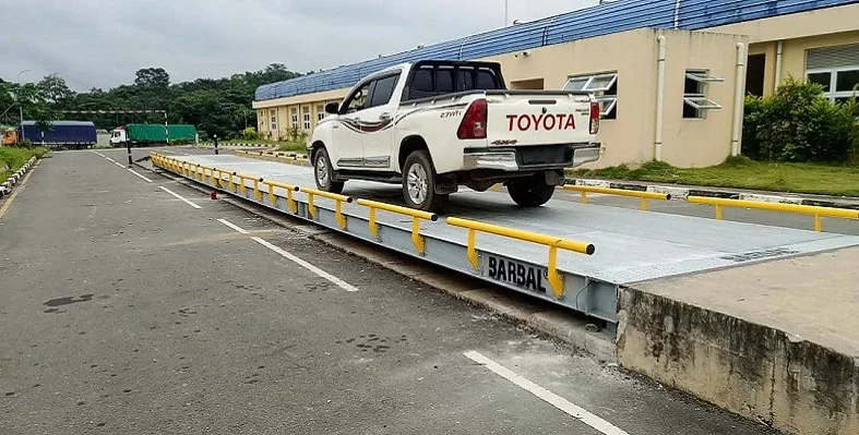 A car going over the weidhbridge at the border crossing.