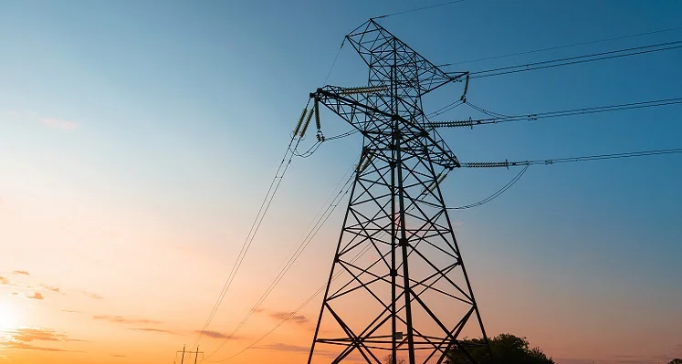 An energy pylon against a setting sky. 