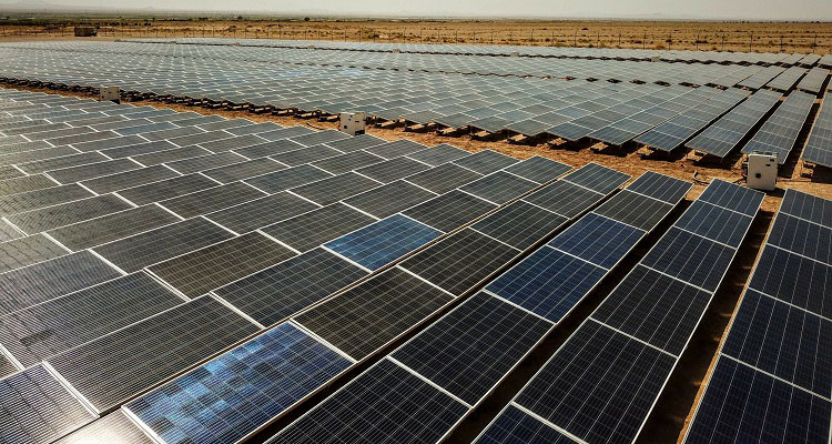 An overhead shot of a solar farm with hundreds of panels. 