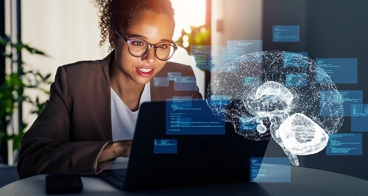 An employee working on a laptop with an AI digital image imposed over the front. 