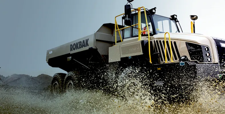 A Rokbak ADT driving through a puddle.